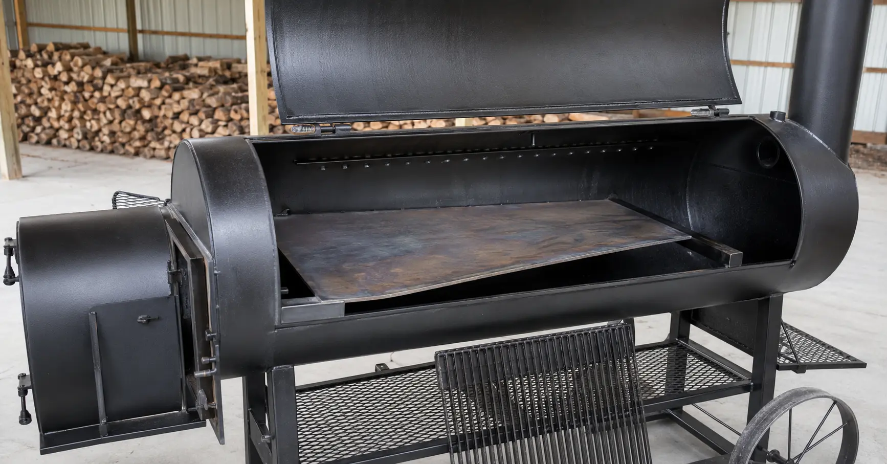 Offset smoker heat diffuser installed below the cooking grate