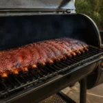 A freshly smoked rack of pork ribs with rich mahogany bark resting on a wooden cutting board