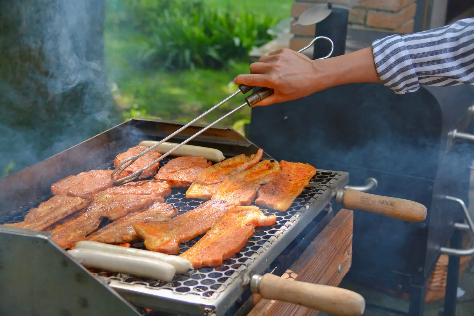 Pitmaster tending an offset smoker
