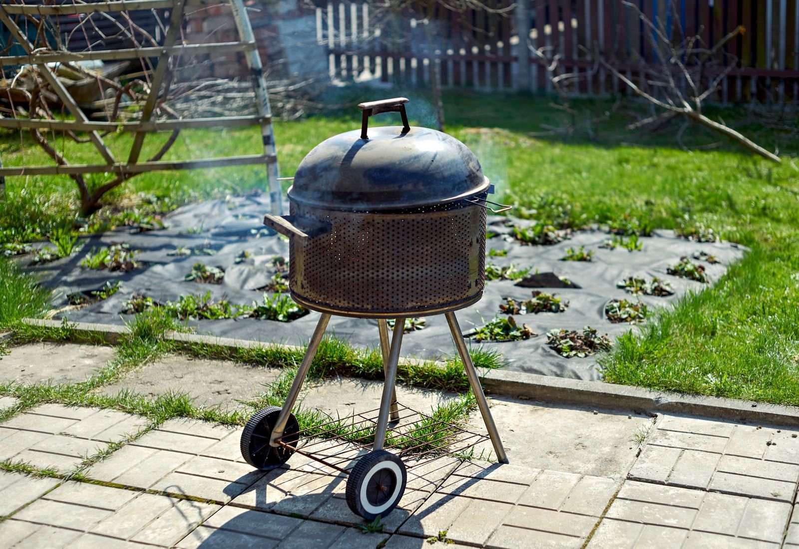 Smoke rising from an offset smoker chimney